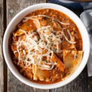 One Pot Lasagna Soup in a white bowl. square image close shot
