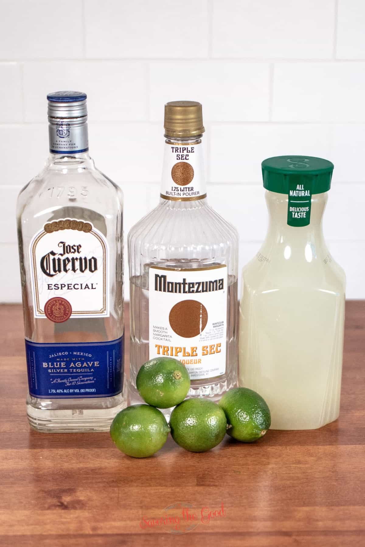 ingredients for to go margaritas, tequila, triple sec limeade, limes.