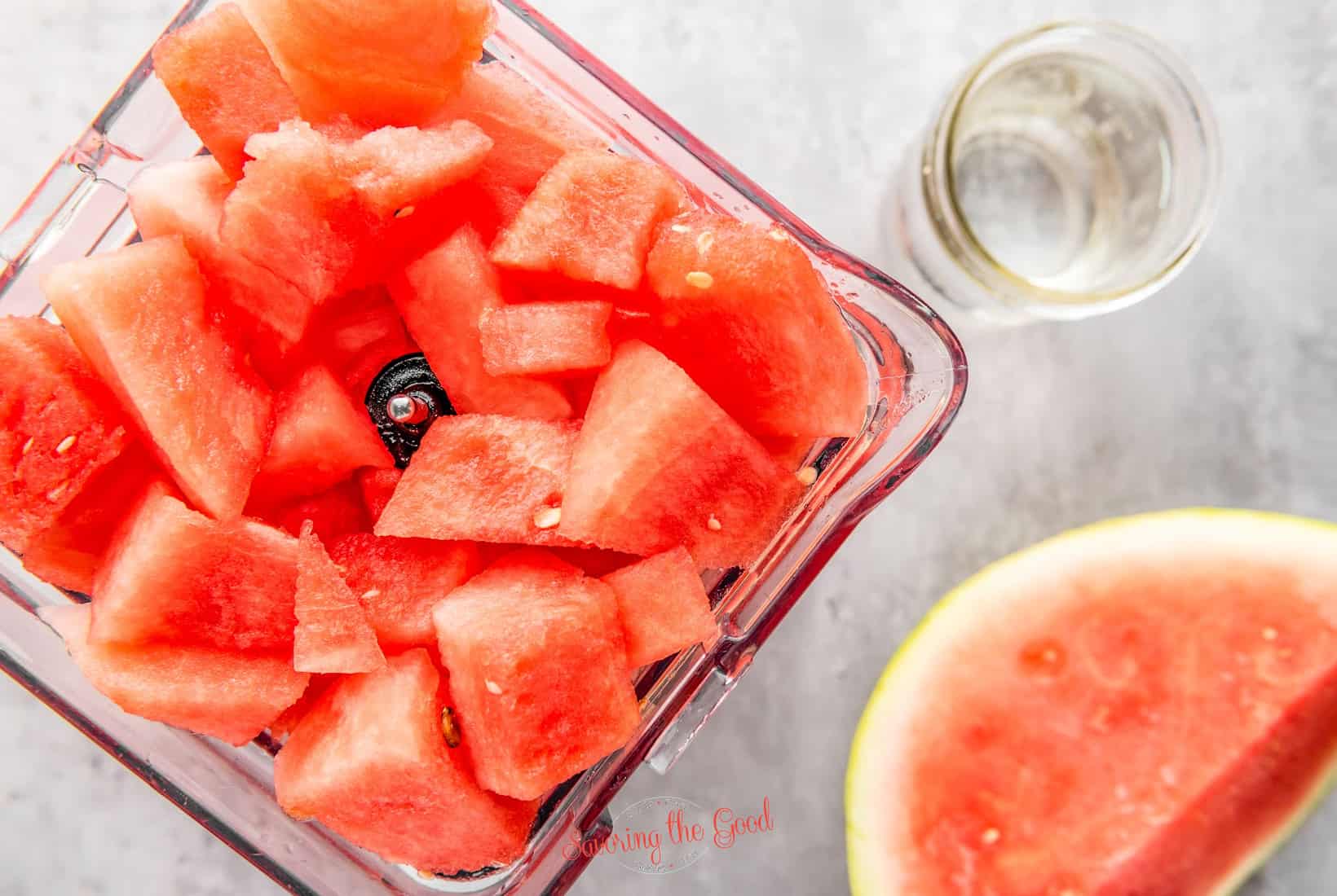 cubes of watermelon in a blender, ready to be blended.