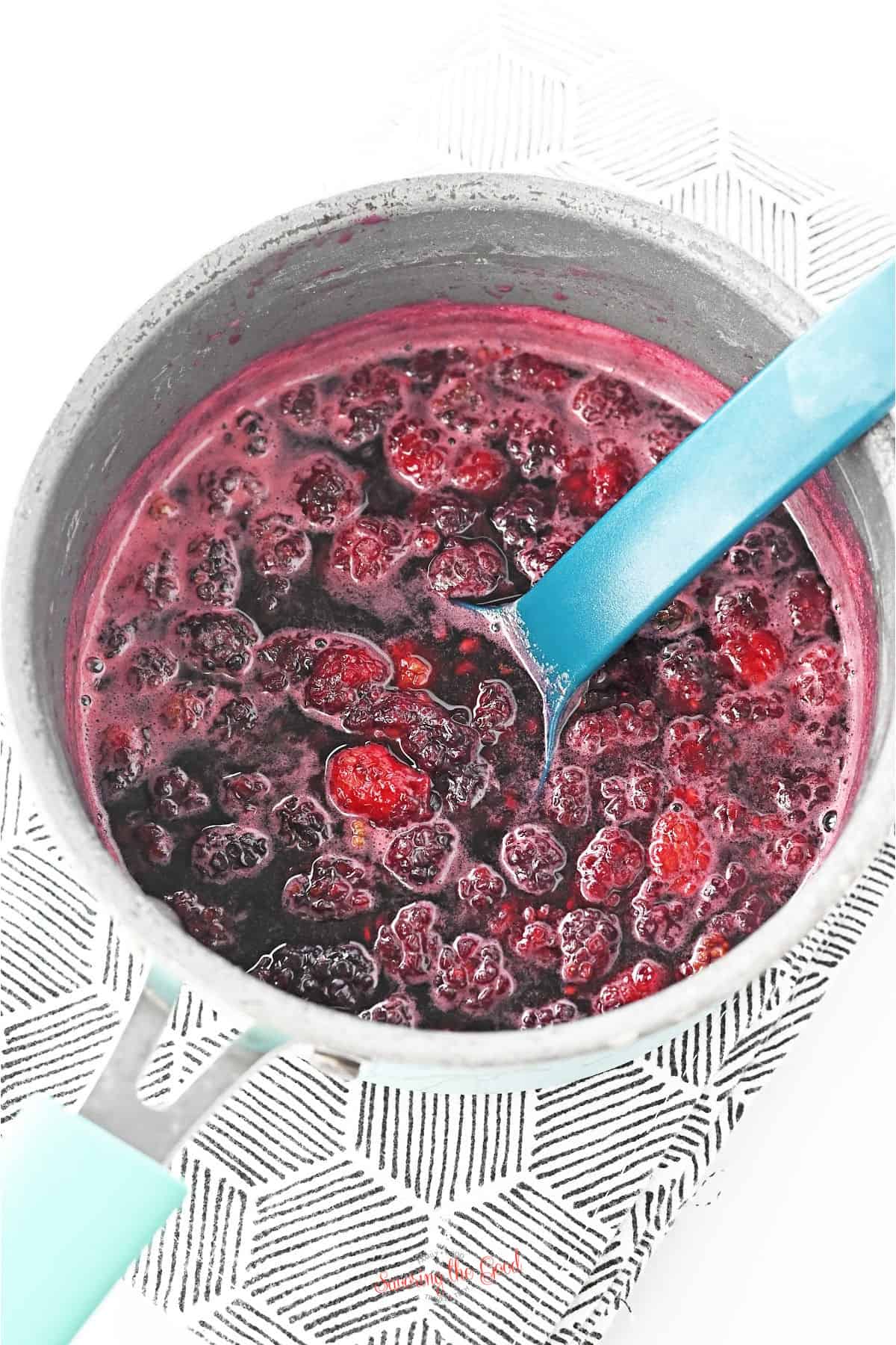 making blackberry syrup in a pan.