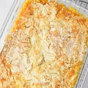 peach dump cake. square image. in a glass pan.