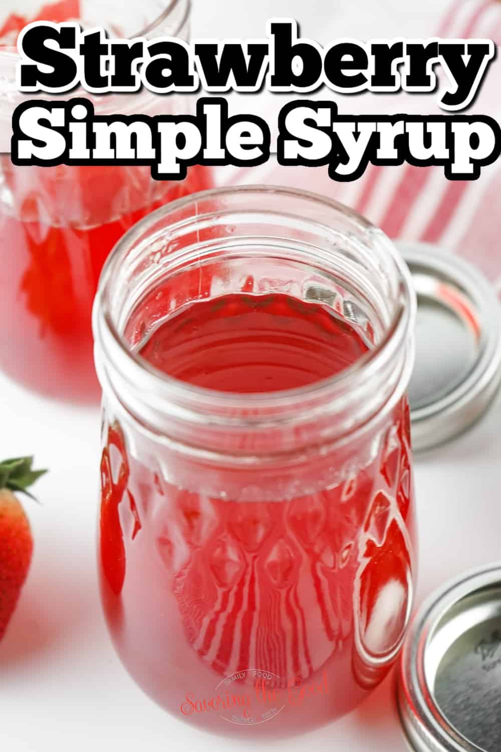 Strawberry simple syrup in jars.