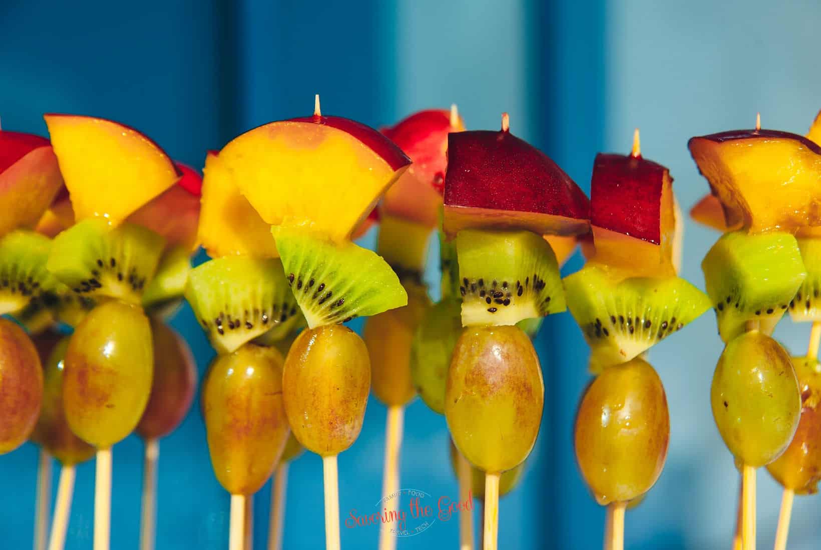 fruit skewers on a blue background.