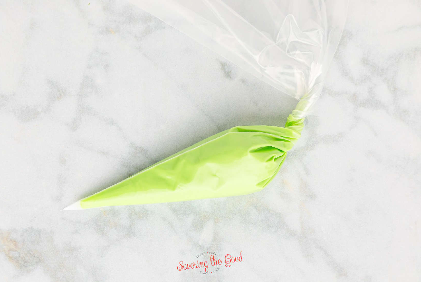 A green plastic cone on a marble table.