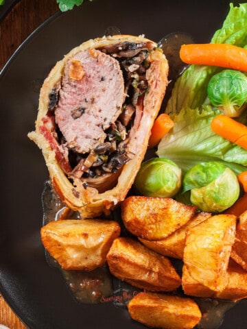 A plate with vegetables and potatoes, perfect as sides for beef wellington.