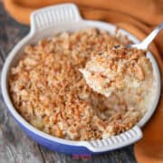 pineapple casserole with a spoon taking out a portion.