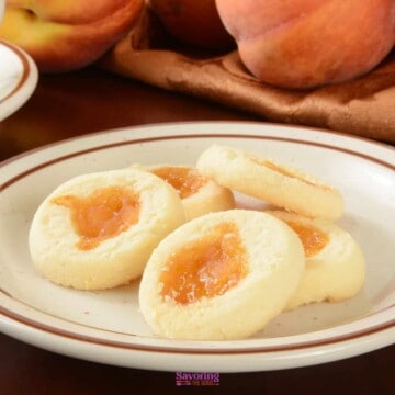 mango thumbprint cookies on a plate.