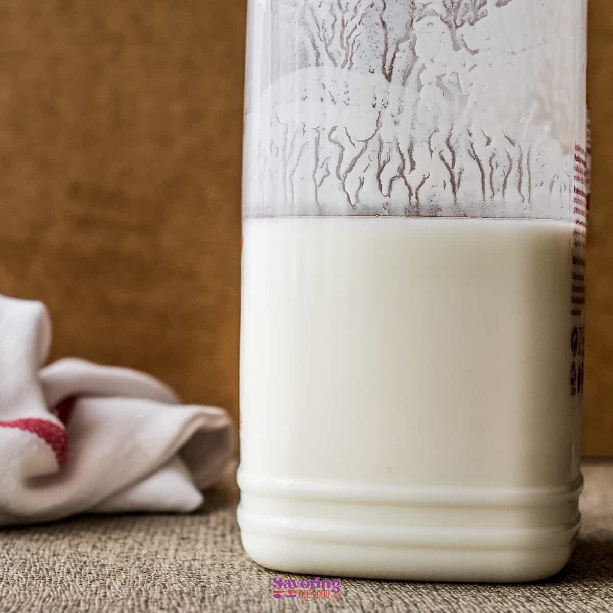 how to make buttermilk featured image of a large glass jar of buttermilk.