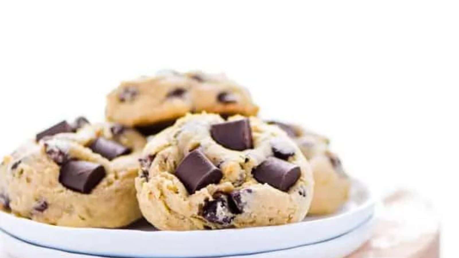 Chocolate chip cookies on a white plate.