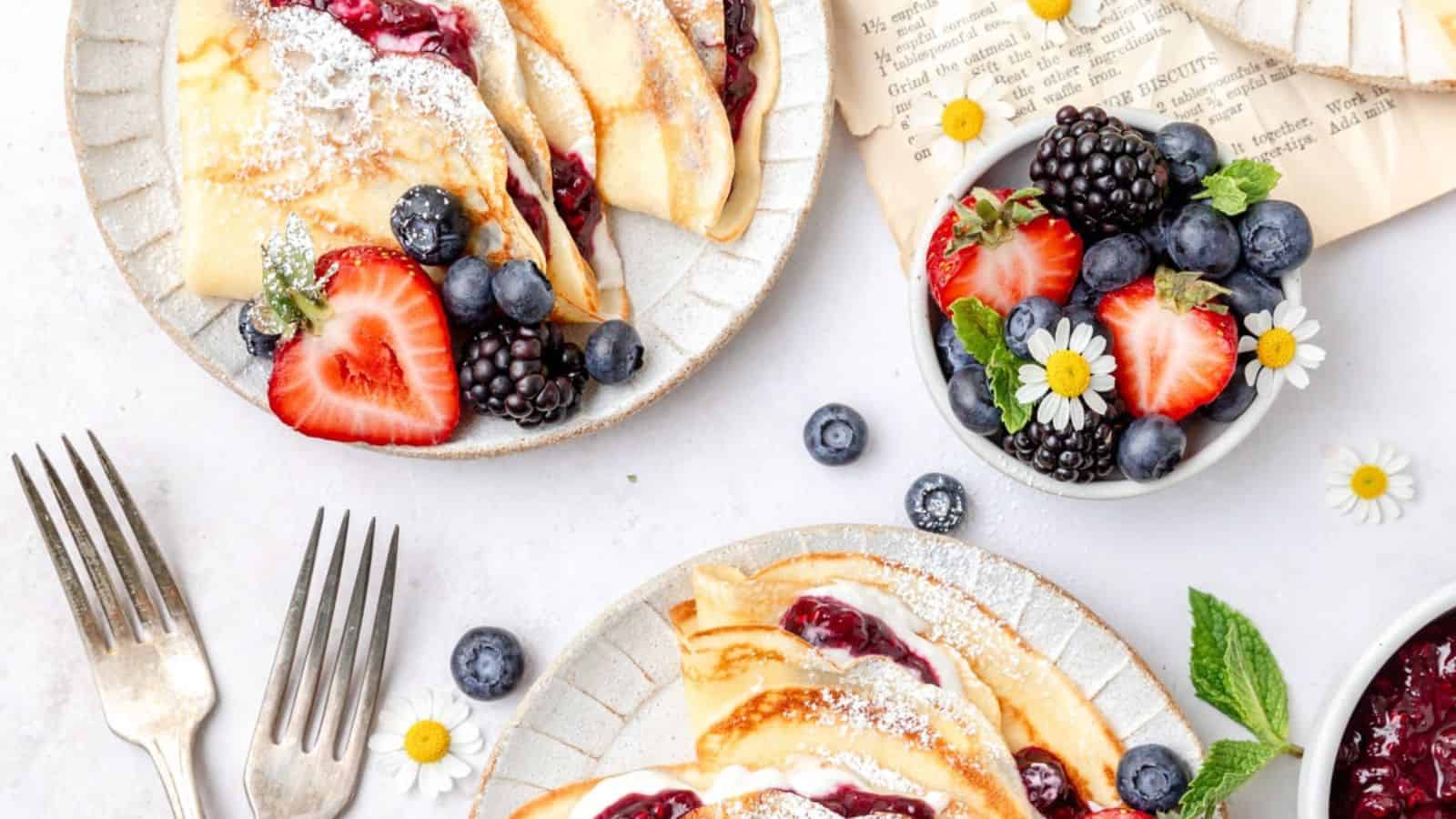 A plate of pancakes with fruit on it.