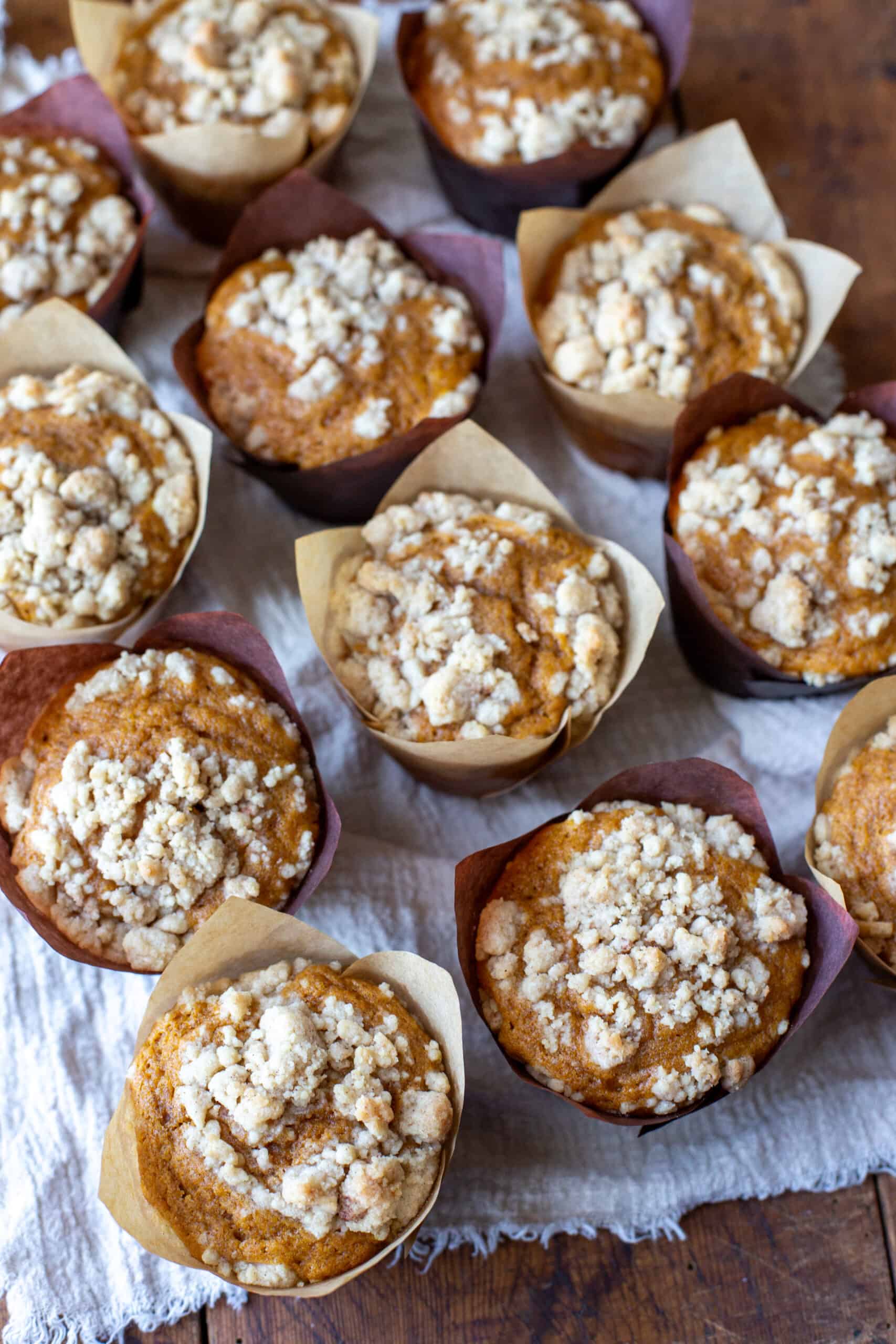 A group of pumpkin muffins on a wooden table.