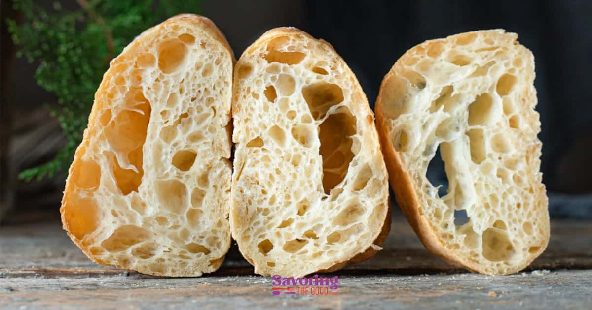 Three slices of bread on a wooden table.