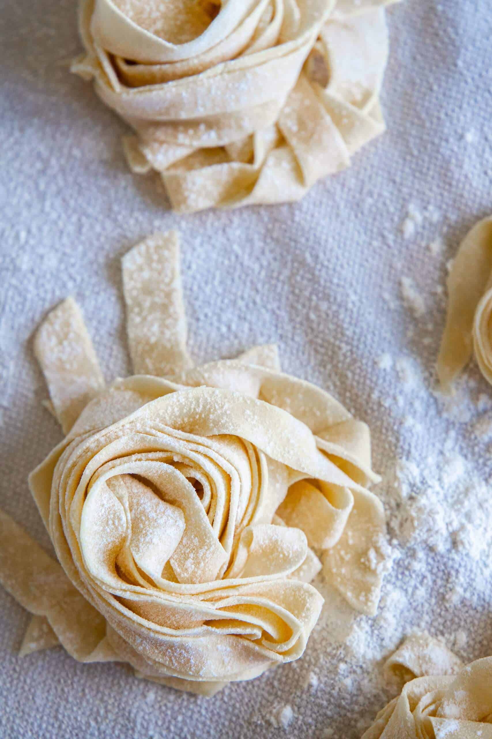 Fettuccine with a rose on a baking sheet.