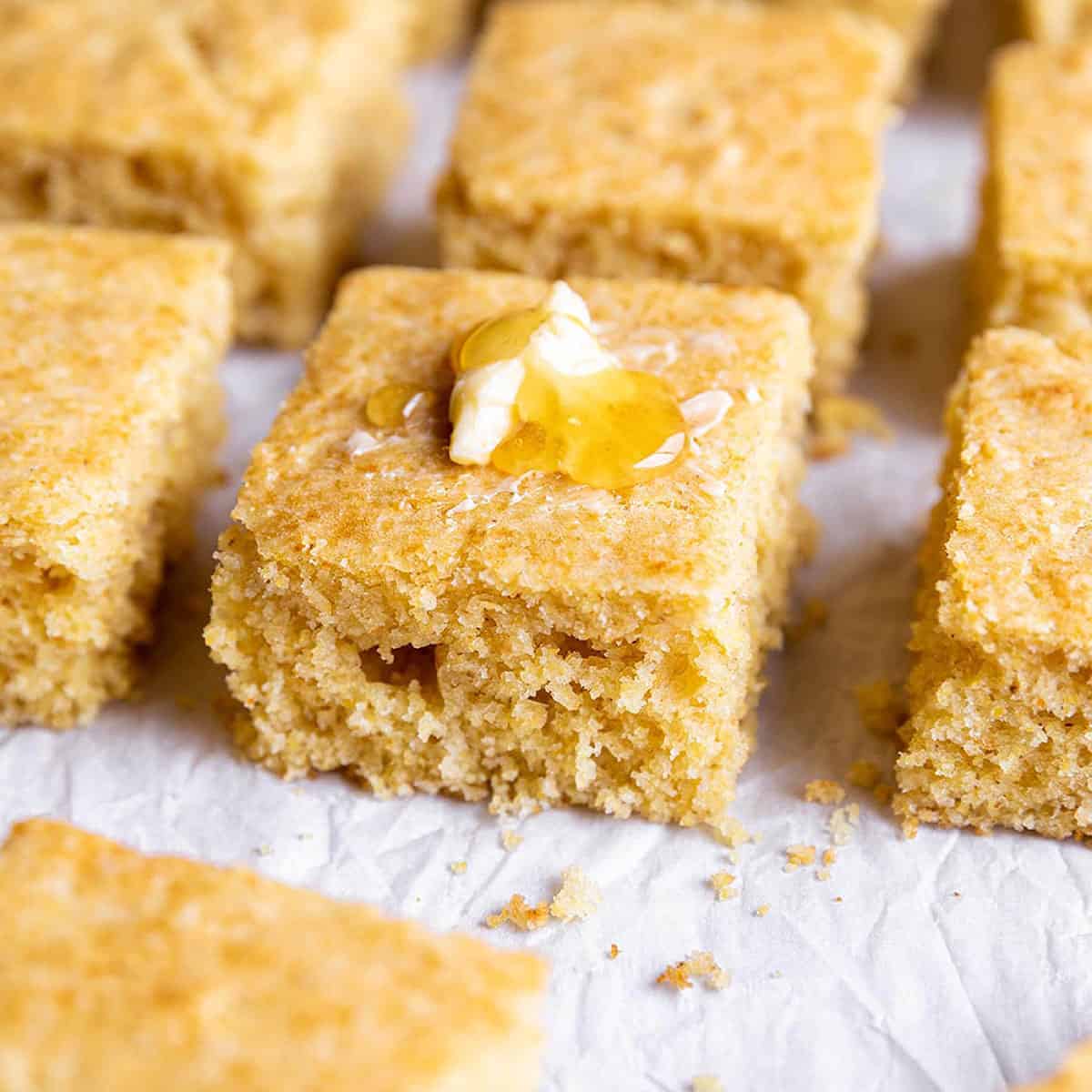 Squares of cornbread with honey on top.