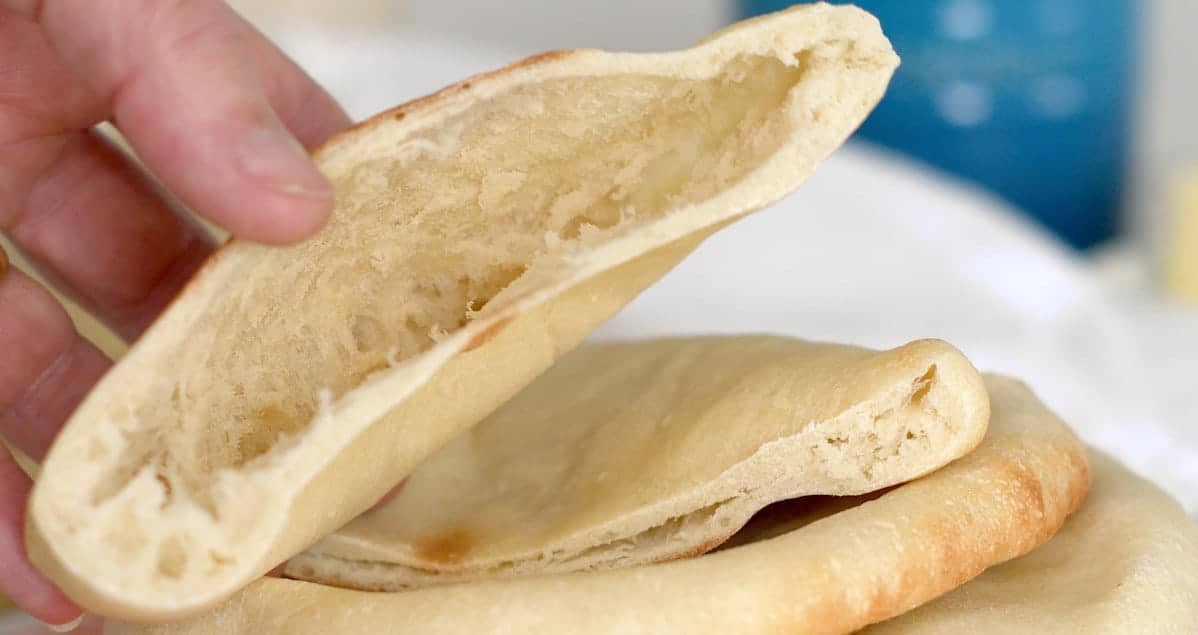 A hand holding a pita bread.