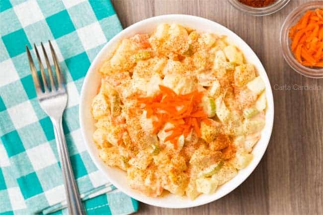 A bowl of salad with carrots and celery.