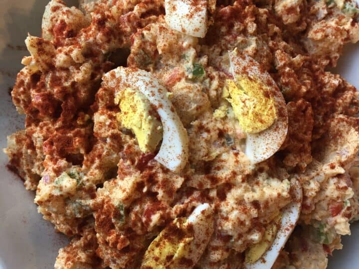 A white plate with a fried egg on top.