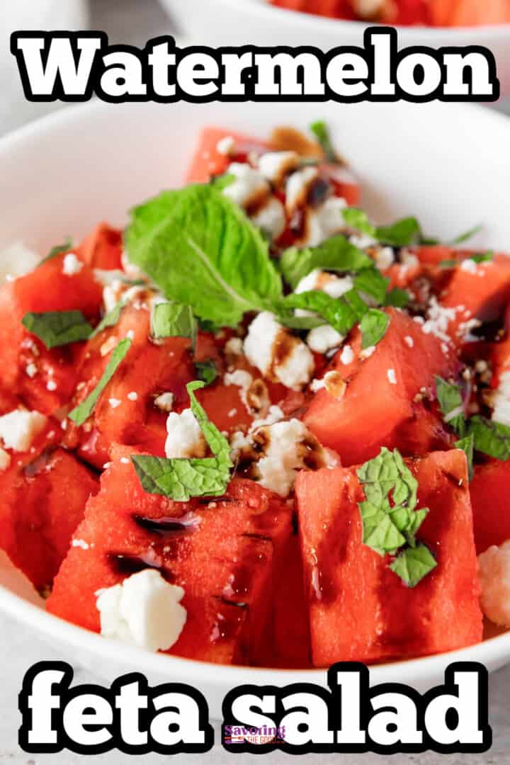 Close-up of a watermelon feta salad in a white bowl, garnished with mint leaves and balsamic glaze. Text overlay reads "Watermelon feta salad.