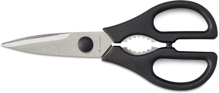 A pair of kitchen shears with black handles, a metal blade with a serrated edge, and a built-in bottle opener between the handles.
