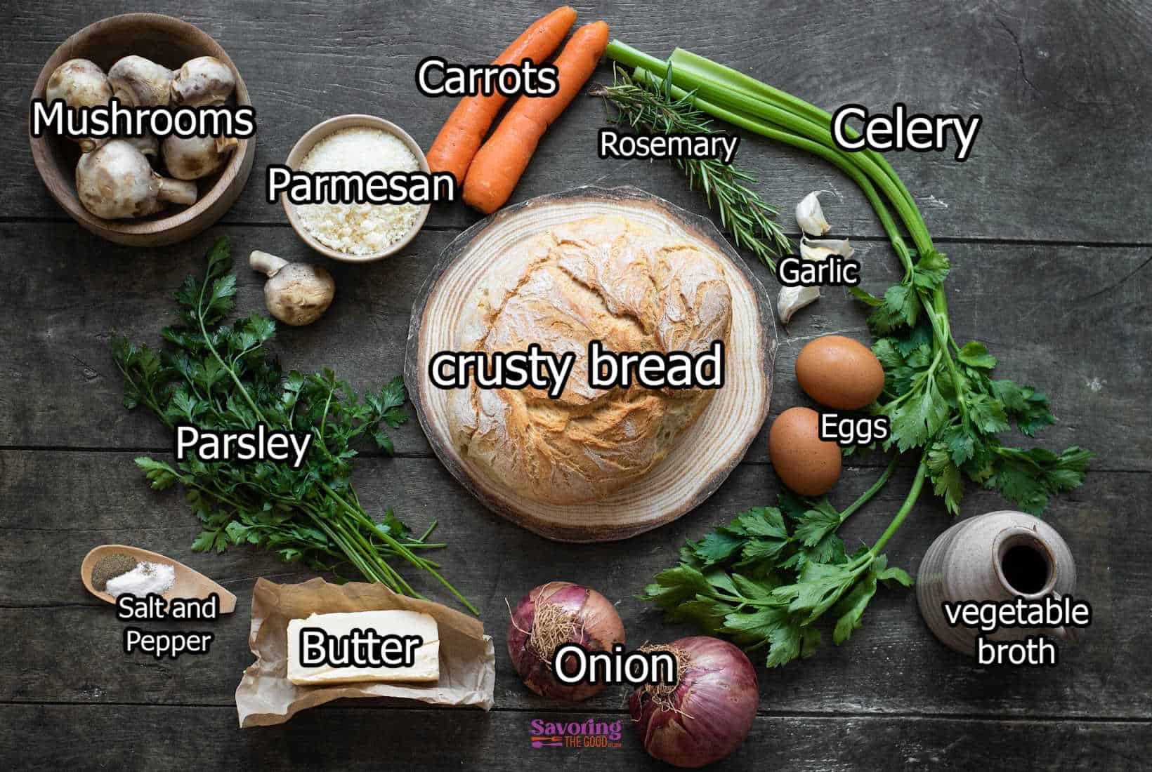 A crusty bread is surrounded by various ingredients including celery, carrots, mushrooms, parmesan, rosemary, garlic, eggs, vegetable broth, onion, butter, salt and pepper, and parsley in this delicious vegetable stuffing recipe.