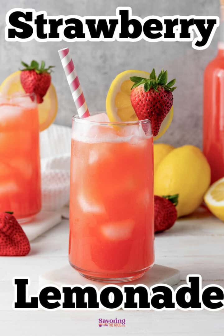 A glass of strawberry lemonade garnished with a lemon slice and a strawberry, accompanied by more strawberries, lemons, and another glass in the background. The text reads, "Strawberry Lemonade.