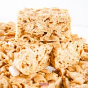 A stack of crispy cereal bars with a light brown color and a textured surface, reminiscent of cinnamon toast crunch bars.