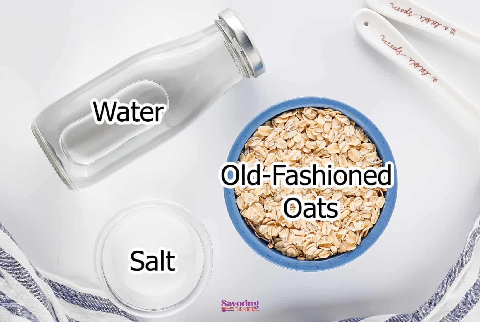 On a white surface, a milk bottle boldly labeled "Water," sits beside a bowl marked "Old-Fashioned Oats." Nearby, a container labeled "Salt" completes the scene with measuring spoons. It's as if the universe is hinting at a unique oatmeal milk creation waiting to unfold.