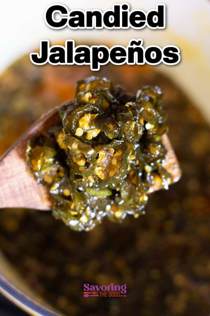 Close-up of candied jalapeños on a wooden spoon with scattered seeds, against a blurred background. Text above reads "Candied Jalapeños" in bold letters.