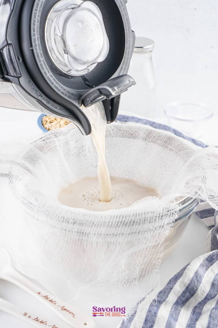 An appliance pours liquid into a bowl lined with cheesecloth for straining.