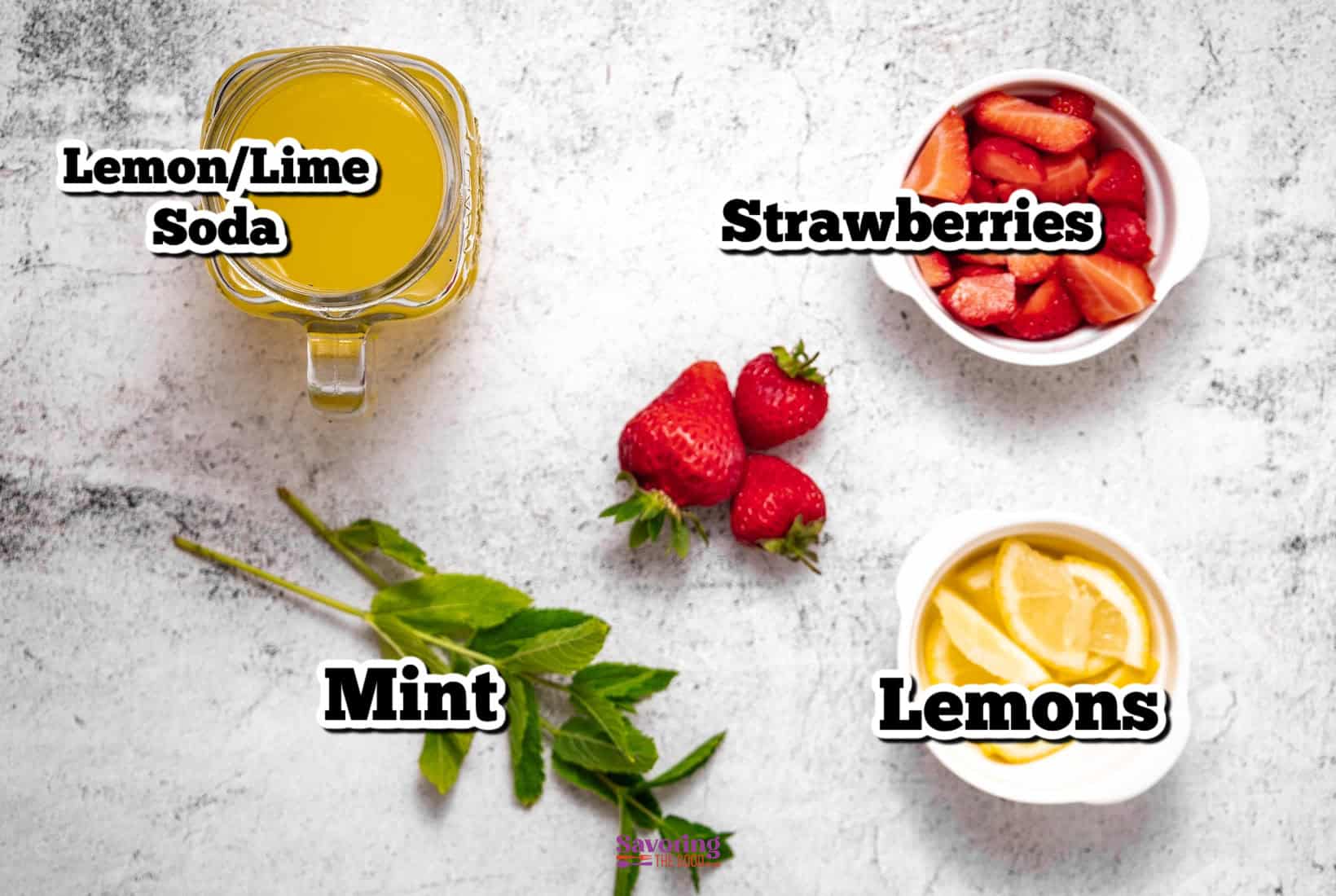 Glass of lemon/lime soda, bowl of sliced strawberries, and a bowl of lemon slices adorned with mint leaves create the perfect mocktail with strawberries on a light textured surface.