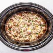 Crockpot French onion meatballs, perfectly slow-cooked with cheesy goodness and topped with fresh herbs in a rich, dark sauce.