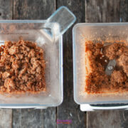 Two clear blender containers on a wooden surface; the left contains chunky ground meat, perfect for a hearty calabrese pasta sauce, and the right has more finely blended meat with visible blades.