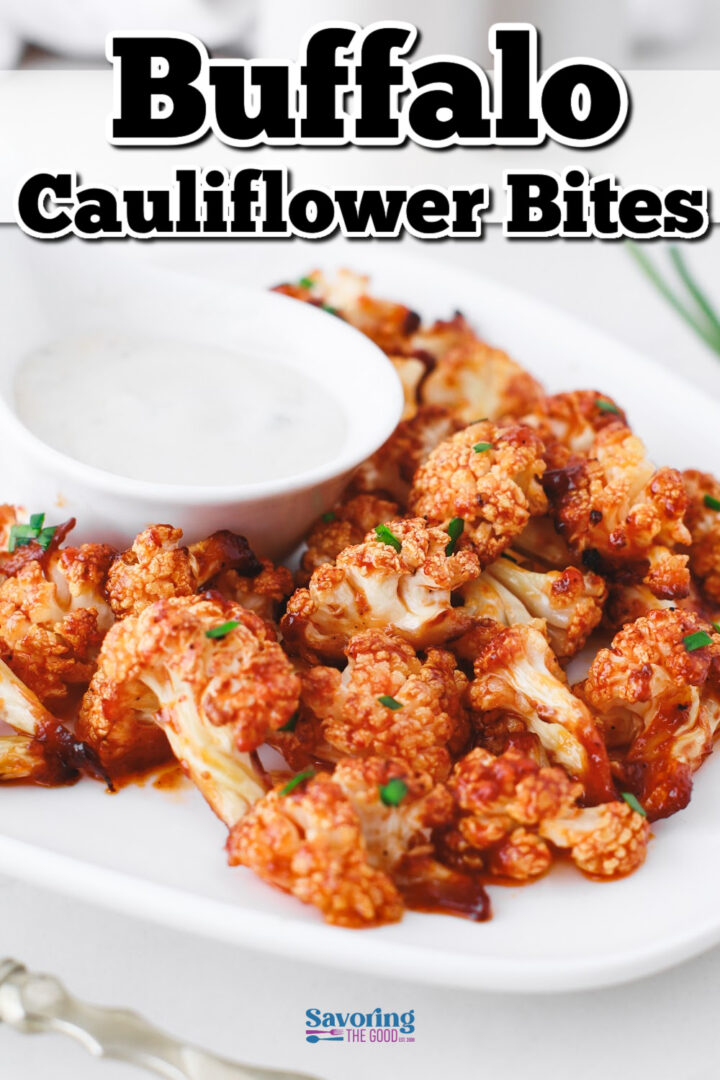 A plate of buffalo cauliflower bites garnished with herbs, served with a side of dipping sauce.