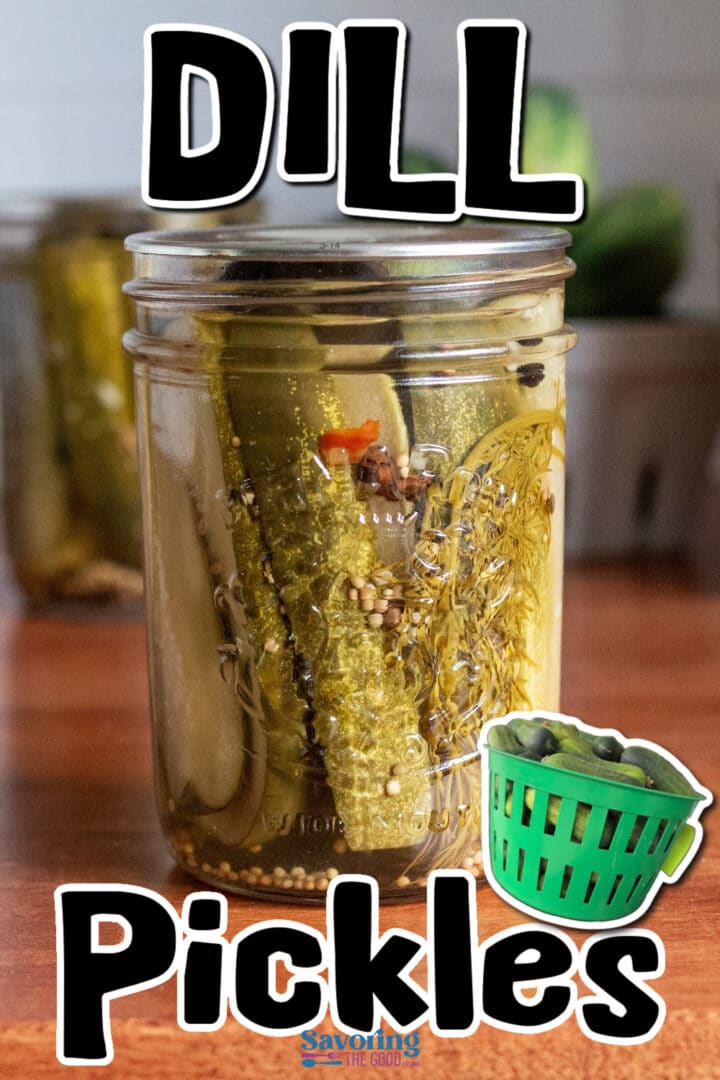 Glass jar filled with dill pickles in brine, with visible spices and garlic, sitting on a wooden surface. Text reads “DILL Pickles” with a small graphic of a green basket of pickles.