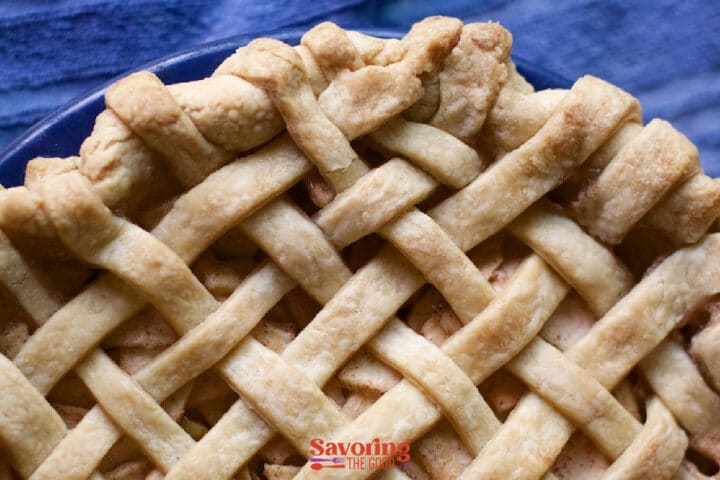 Baked lattice top crust on an apple pie made with the Crisco pie crust recipe, showing flaky layers in the fluted edge.