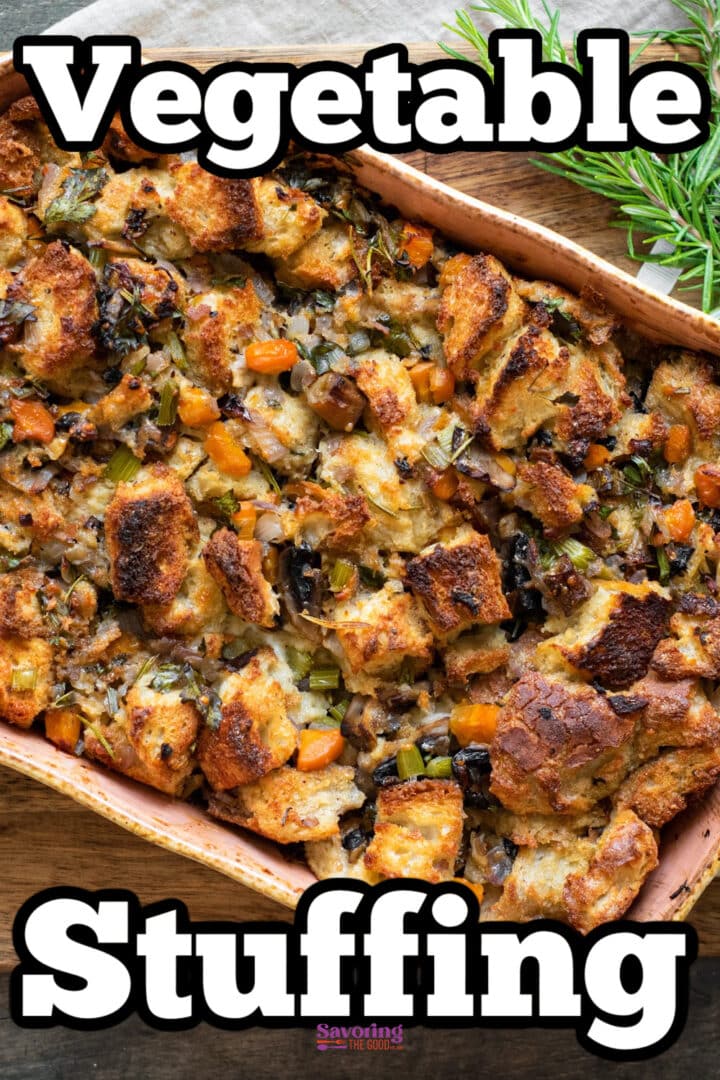 Baked vegetable stuffing in a rectangular dish, featuring toasted bread cubes, carrots, celery, and herbs.